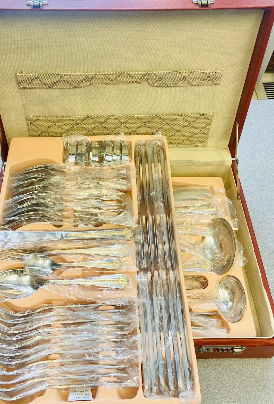 Set of silverware in a case on a table.